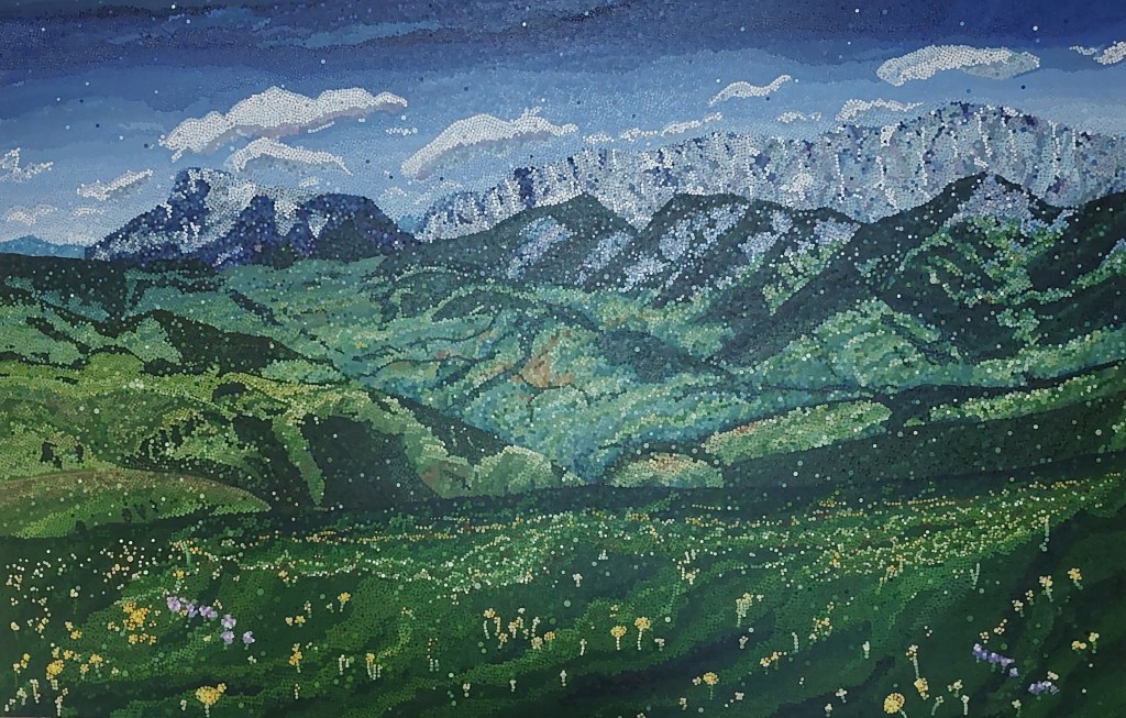 A large landscape painting showing mountains in the far distance.